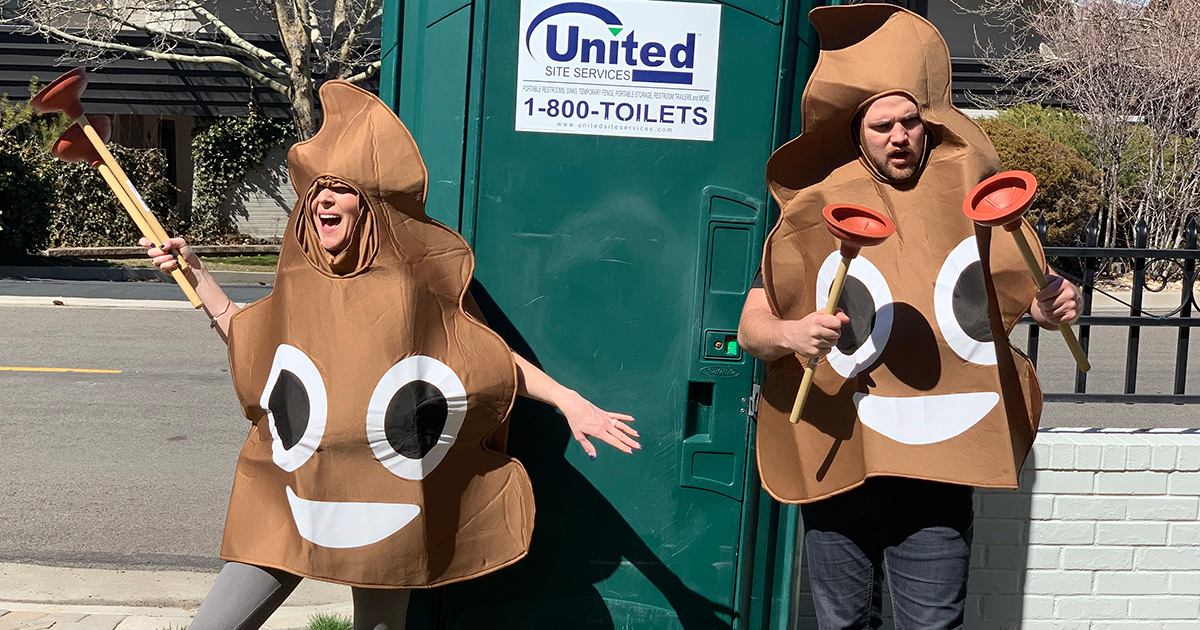 collin and stetson outside of port-a-potty in poop costumes