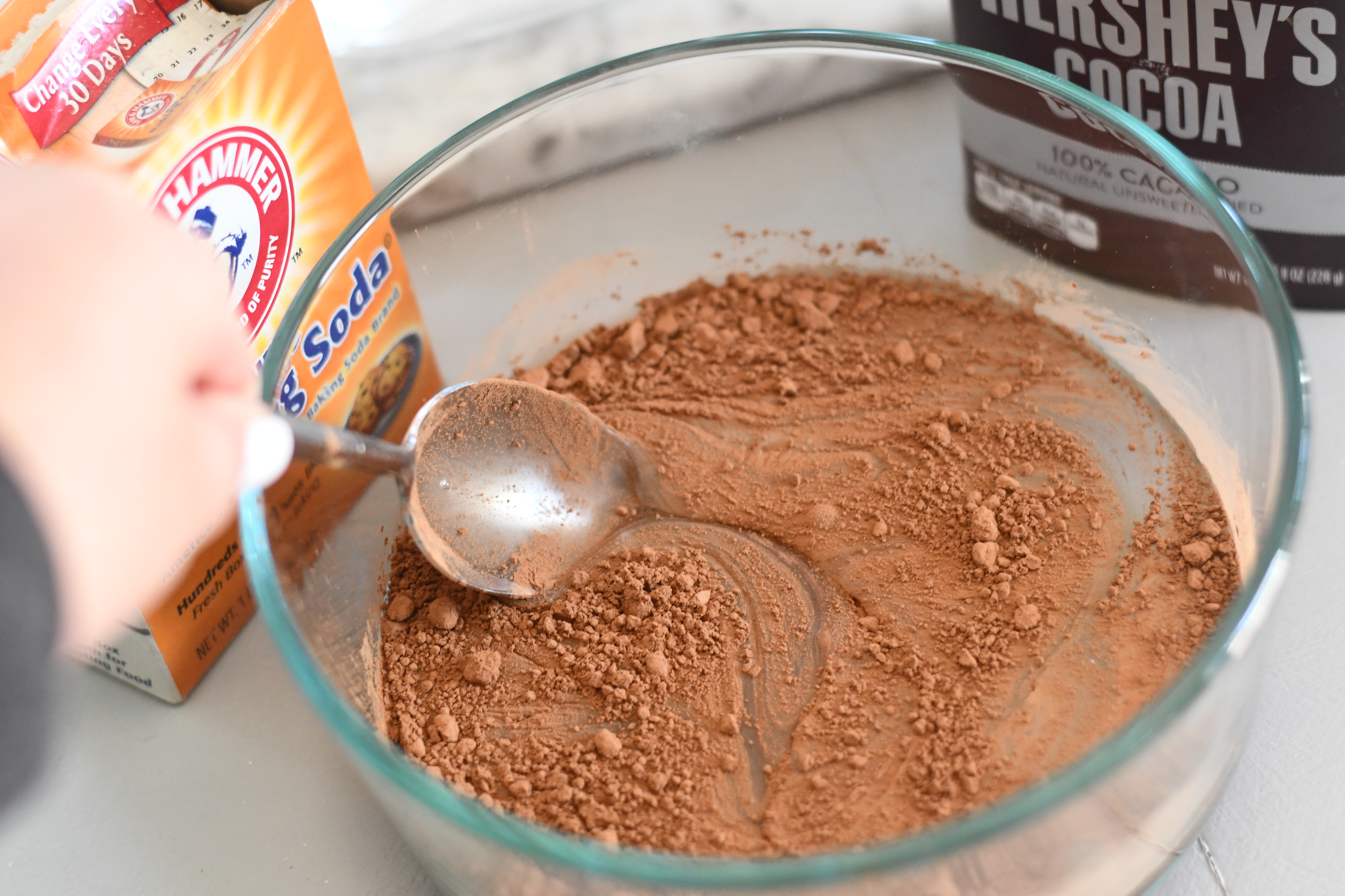 stirring poop slime in a bowl with cocoa powder